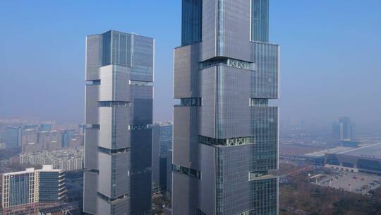 郑州绿地中心双子塔商业大楼航拍旋转由远近
