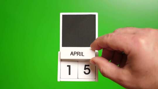04.绿色背景上日期为4月15日的日历。