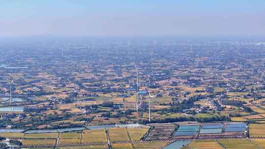 航拍平原农村乡镇风力发电机稻田鱼塘民房