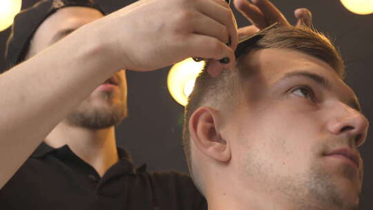 理发师在沙龙用发刷和剪刀梳理和剪裁