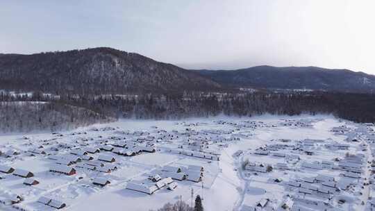 航拍新疆禾木雪景森林雪地小木屋禾木桥雪山