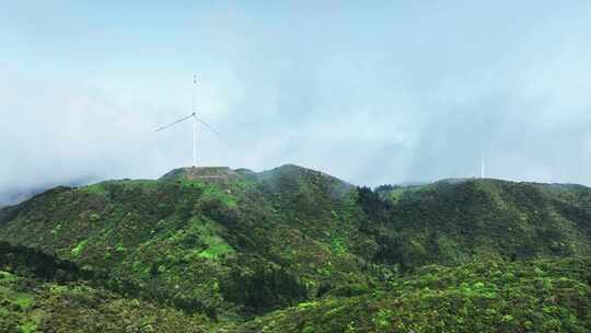 阳光下桂林高山上的云海与风力发电风车