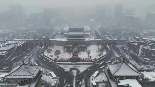 航拍陕西省西安市西安古城城楼大雪纷飞景观