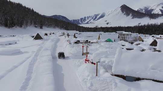 航拍冬季新疆阿勒泰禾木雪景雪山森林村落