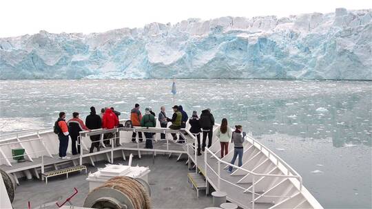 站在船头欣赏冰川美景的人