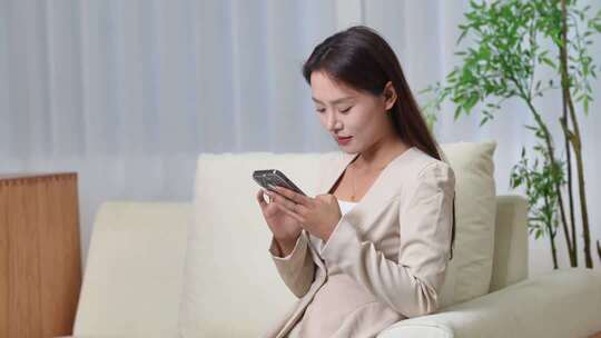 美女沙发上专注看手机