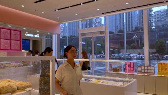 女生在蛋糕店甜品店买完东西拉门出去视频素材模板下载