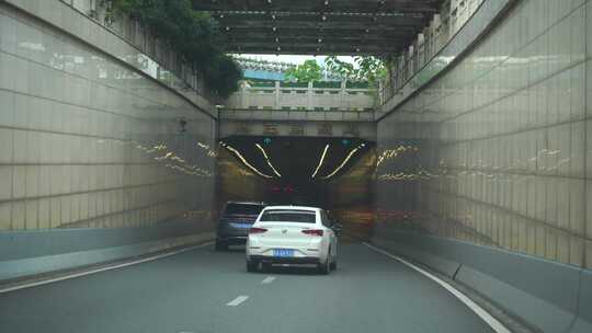 开车行驶在城市隧道路交通车流城市窗外风景
