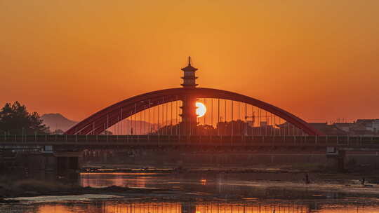 夕阳下带古塔的拱形桥景观