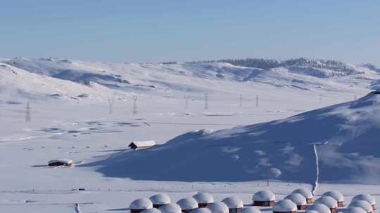 航拍新疆阿勒泰吉木乃草原石城雪景输电线路