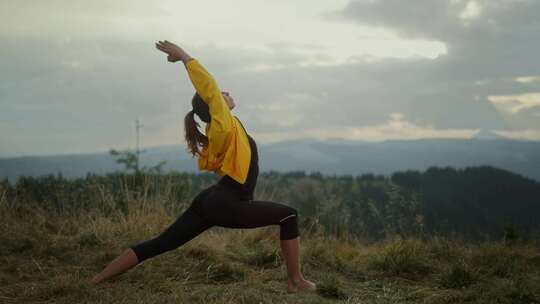 在山顶上做瑜伽健身操的女人