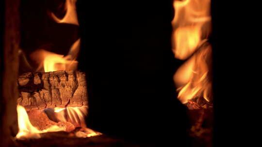 往燃烧的木炭篝火柴火添柴