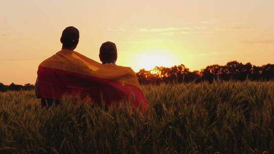 两个人坐在草地上看日出