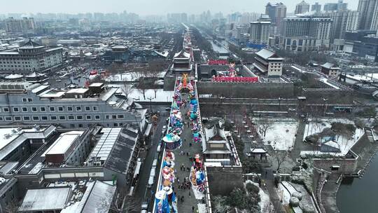 航拍陕西省西安市西安古城城楼大雪纷飞景观