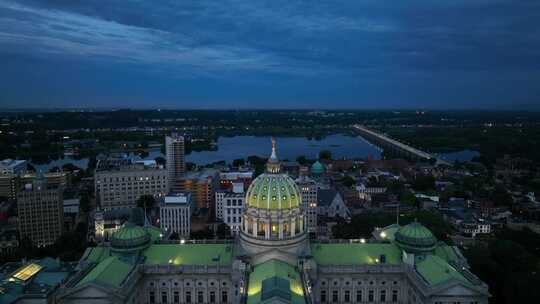 宾夕法尼亚州政府大楼的上升天线。哈里斯堡国会大厦圆顶，夜晚的萨斯奎哈纳河。
