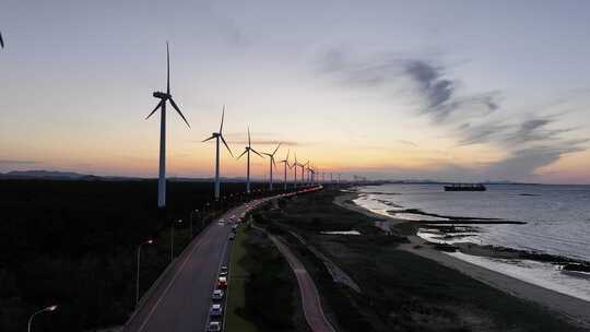 航拍山东荣成环海路风力发电机群晚霞落日