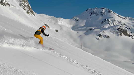 晴天高山滑雪女子在滑雪坡上大转弯的视频视频素材模板下载