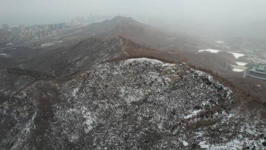 航拍俯瞰飞雪中的威海里口山群山