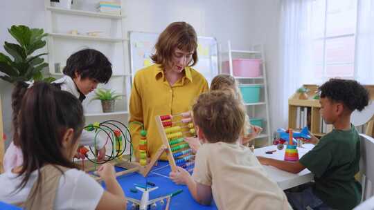 可爱的幼儿学生在幼儿园玩教育玩具。