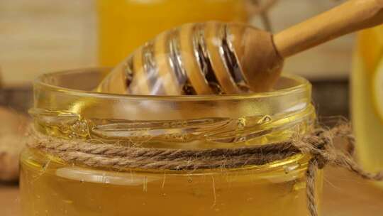 蜂蜜从勺子纺锤流入一罐蜂蜜视频素材模板下载