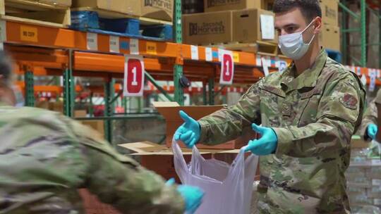 疫情影响下美国国民警卫队士兵在分发食物