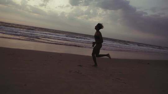 女孩在海边沙滩跑步的慢镜头