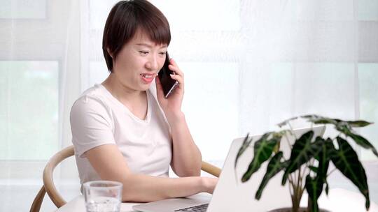 在家办公使用移动电话的亚洲女性