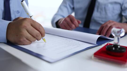 客户在商业合同落款签字并握手