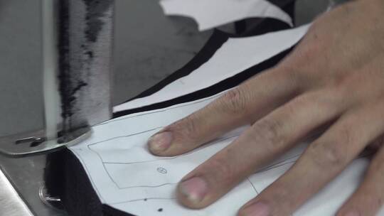 服装厂制衣车间工人机械化裁剪布料面料