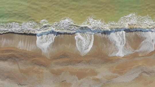 航拍俯拍海浪打在沙滩上空镜头