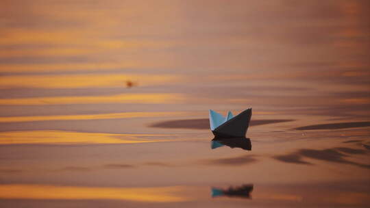 傍晚水上的折纸船