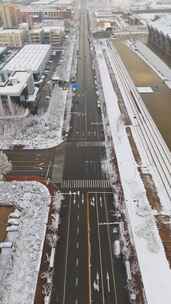 冬季航拍哈尔滨大雪中的城市道路和建筑