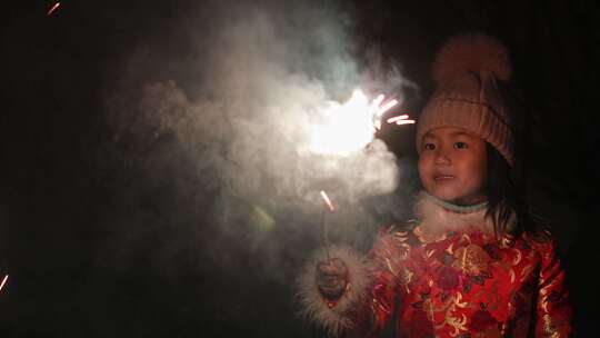 新年穿着红衣服点燃仙女棒的可爱小女孩视频素材模板下载