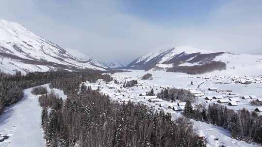 航拍新疆禾木雪景森林雪地小木屋禾木桥雪山