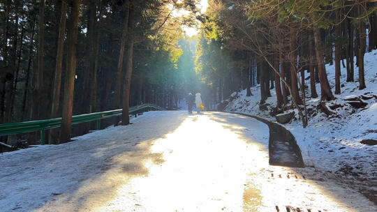 冬天积雪山路上行走的人