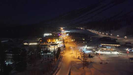 航拍新疆喀纳斯老村冬季夜景雪地小木屋