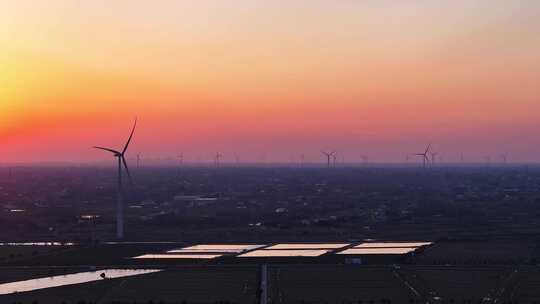 航拍夕阳日落水上风力发电机组湖泊