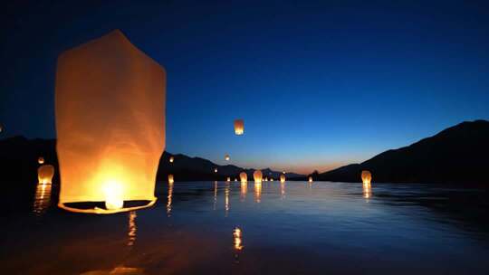 夜晚水面放飞孔明灯场景