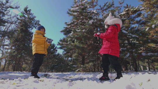 快乐儿童在雪地里打雪仗