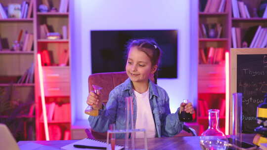 高加索女孩科学家坐在桌旁玩化学设备