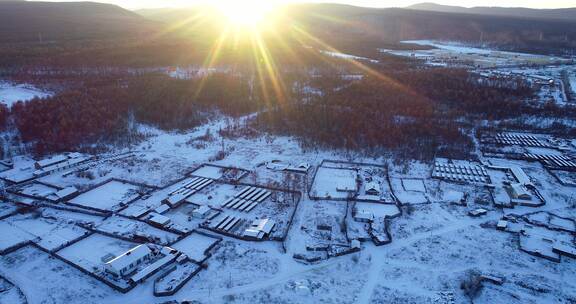 航拍大兴安岭寒冬季日暮时分雪村人家