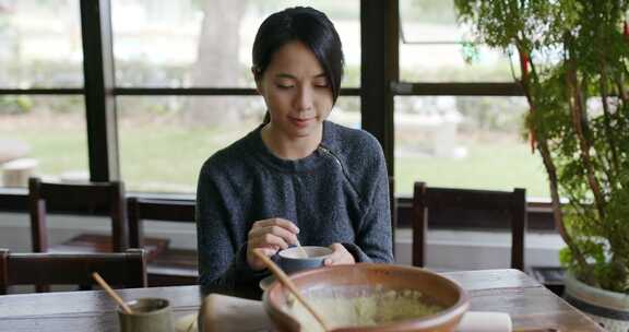 女人制作传统中国磨碎的茶