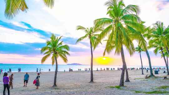 海南三亚日落黄昏时的椰树椰林沙滩大海旅游