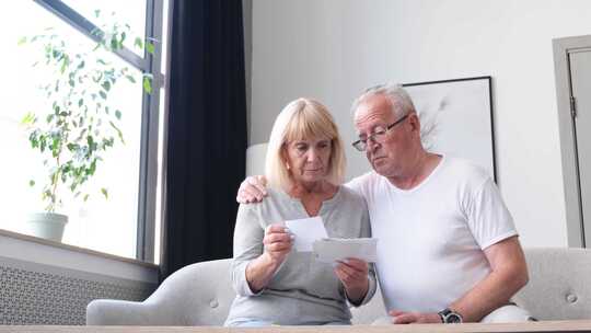 让老年夫妇在家中计算家庭预算时检查财务文件感到不安