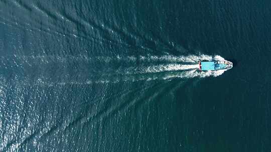 航拍在蓝色海面上航行着的渔船视频素材模板下载