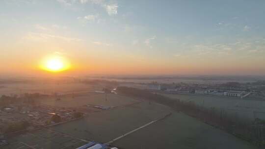 日出下的乡村田野与城镇全景