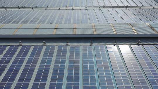 航拍现代工厂房顶太阳能光伏发电站