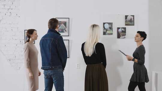 女导游给游客讲解美术馆的展品视频素材模板下载