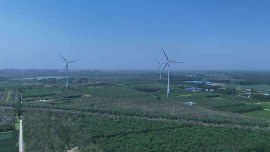 村镇城市绿色庄稼地树林风力发电大风车视频素材模板下载