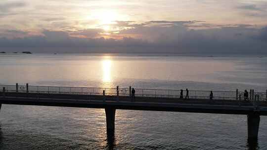 北海海上栈道航拍海边日落晚霞